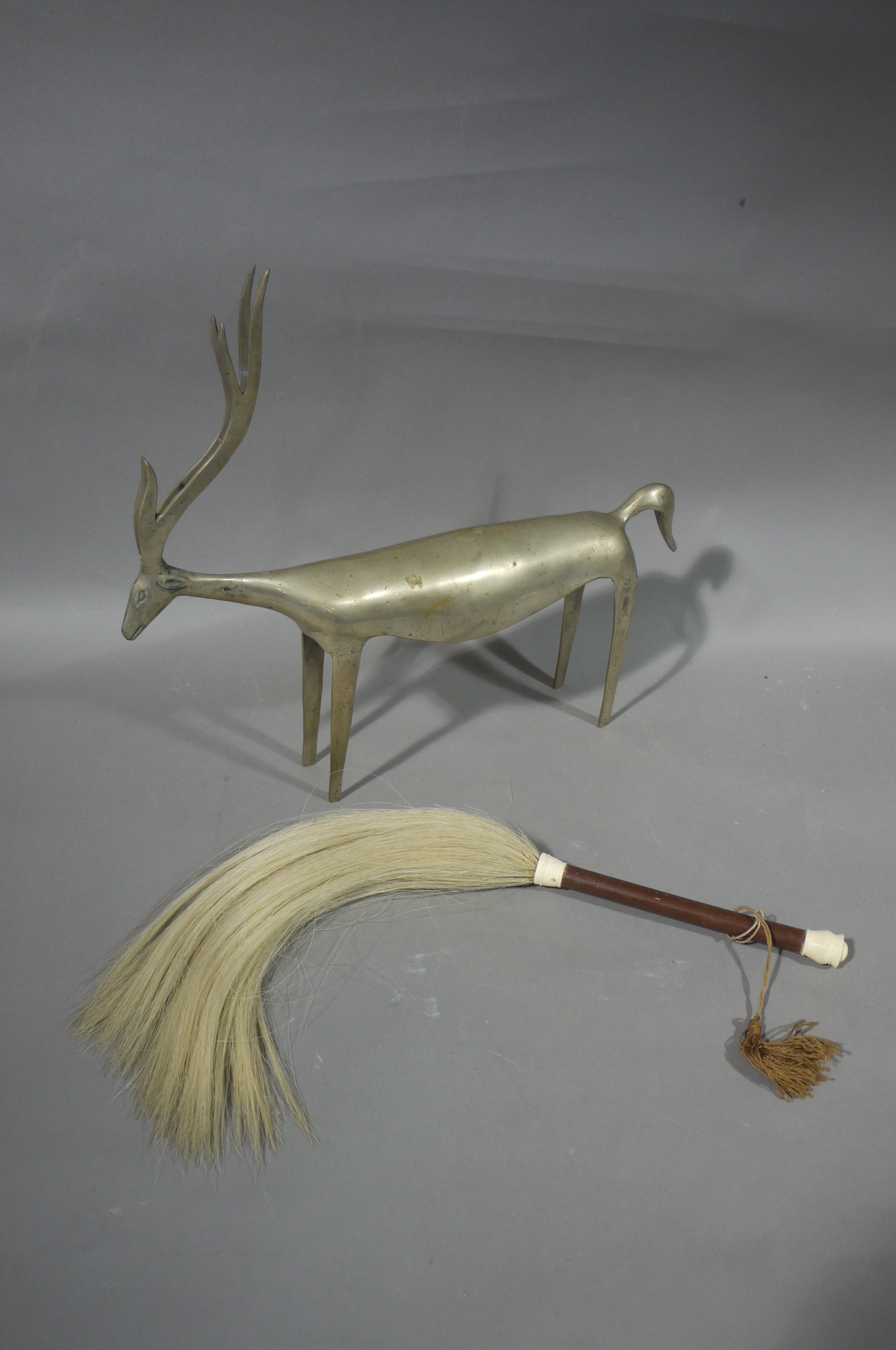 A metal antelope figure and a tribal fly swat (2)