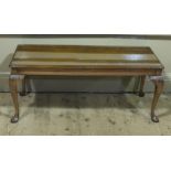 A mahogany effect and glass topped coffee table on cabriole legs