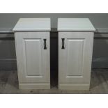A pair of reproduction bedside cupboards with fielded panelled doors,