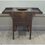 A George IV mahogany gentleman's washstand inlaid in box and ebony stringing having a fold out top,