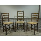 A reproduction rush seat ladder back dining chairs;