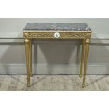 A reproduction marbled topped gilt wood side table the front and sides applied with moulded leaf