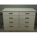 A reproduction bedroom chest of eight drawers matching the preceding lots,