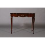 An Edwardian mahogany desk, serpentine shaped back, bow front sides,