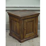 A hardwood single door cabinet on plinth base