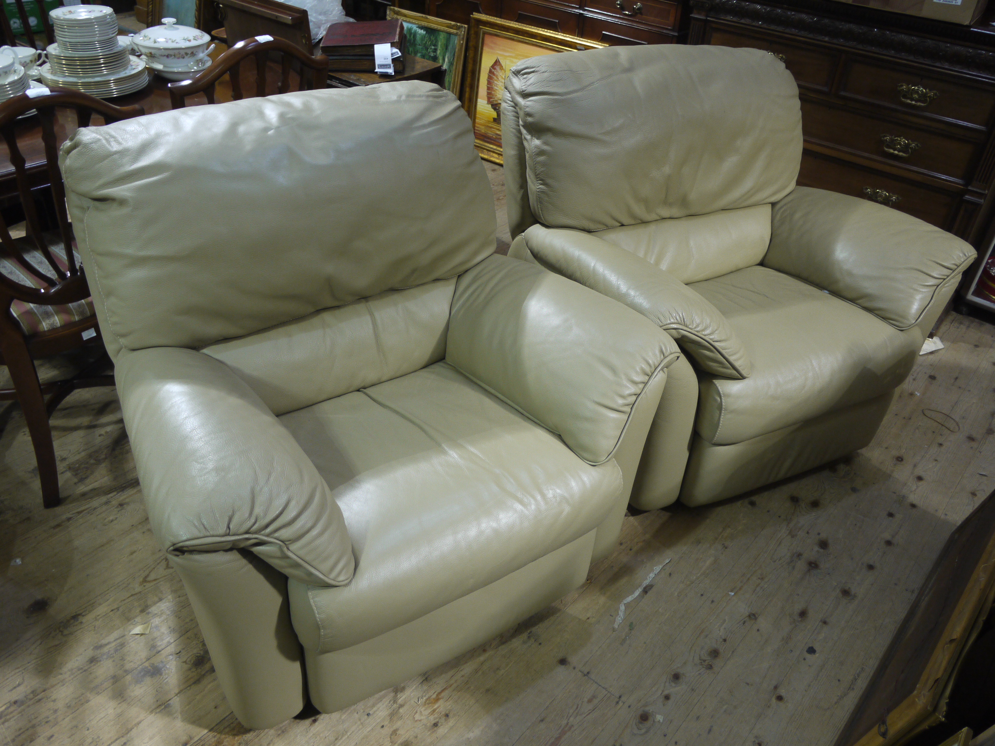 Two putty coloured leather armchairs,