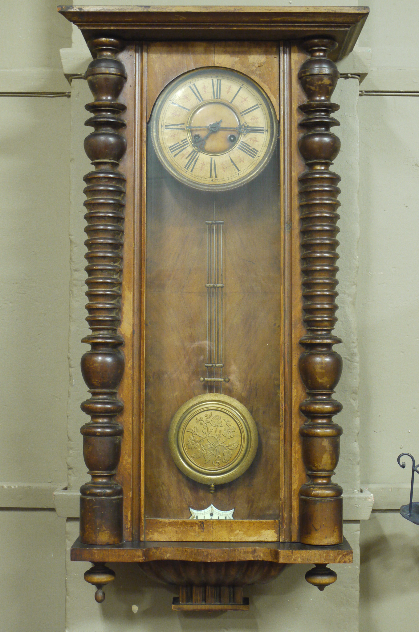 A late 19th century walnut cased Vienna wall clock with papered cream chapter ring,