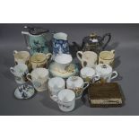 A quantity of commemorative china, two Victorian jugs, a silver plated tea pot,