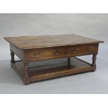 An oak cross banded coffee table rectangular having two drawers to the apron on turned uprights