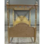 A Victorian style four poster bed with shaped cornice headed by turned finials,