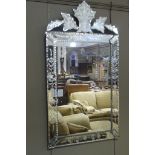 A reproduction Venetian style wall mirror,