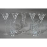 A set of four large wine glasses having slice cut conical bowls on faceted stems, 29.