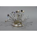 A collection of hat pins, mainly of bead and thistle design,