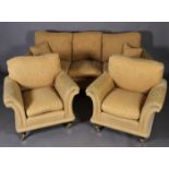 A three piece suite comprising three seater sofa and two armchairs on short mahogany legs with