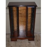 A reproduction mahogany finished CD storage unit on bracket feet