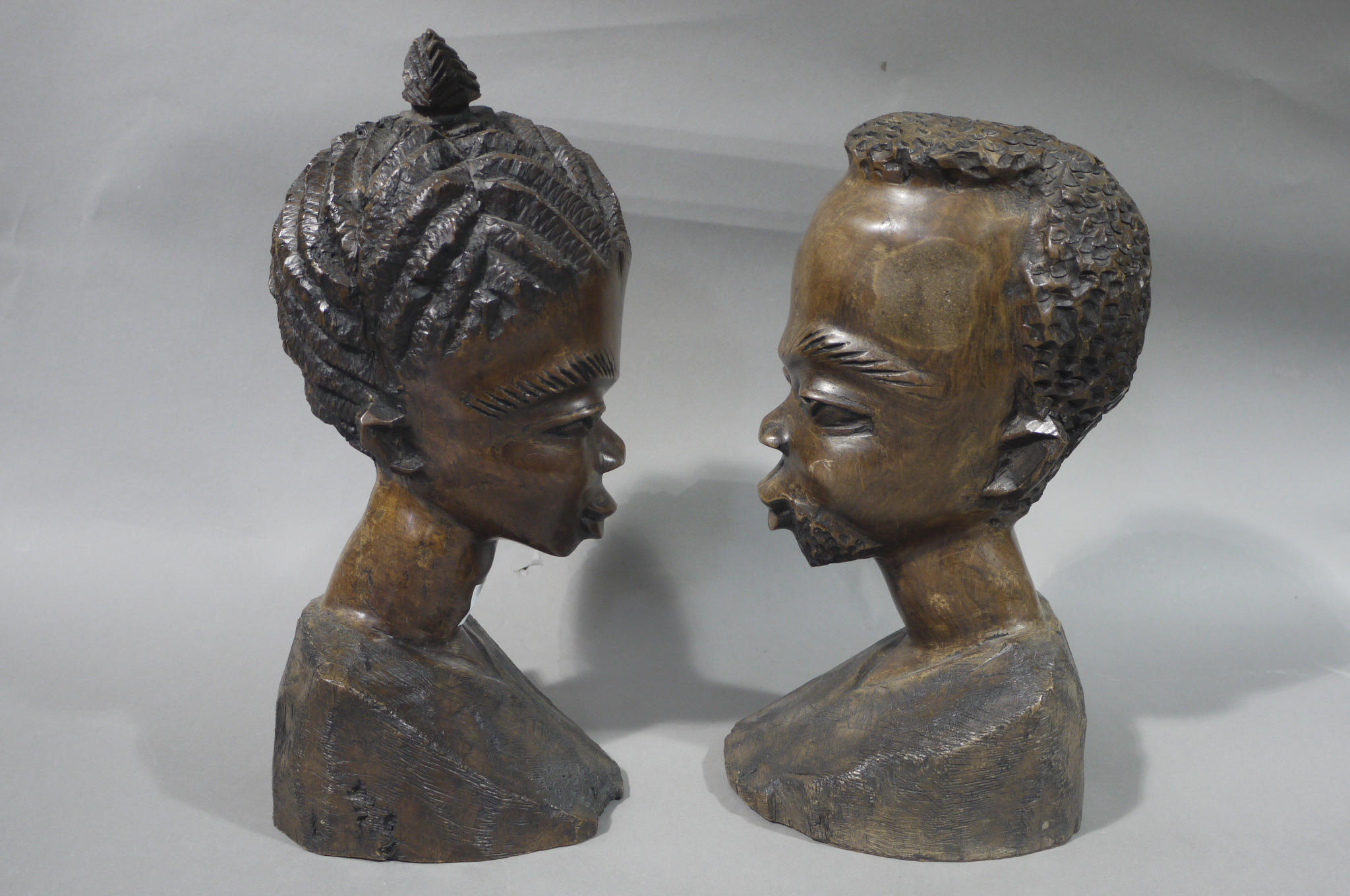 A pair of African carved hardwood tribal busts of male and female,