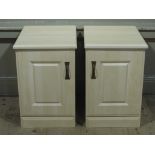 Two reproduction bedside chests with raised fielded panelled doors,