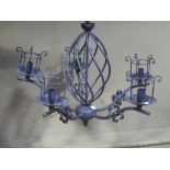 A dark blue metal five branch light fitting with glass shades