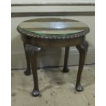 A mahogany circular coffee table with gadroon rim and on cabriole legs with pad feet