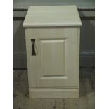 A reproduction bedside cabinet with raised fielded panelled door,