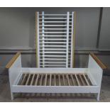 A child's cream painted and pine cot converting to a bed,