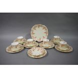 A Royal Crown Derby part tea service printed with rose garlands on an ivory ground, gilt detail,