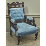 An Edwardian mahogany armchair having swan neck cresting, button upholstered back,