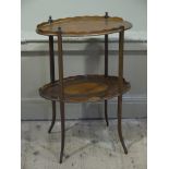 An Edwardian oval two tier occasional table having wavy border,