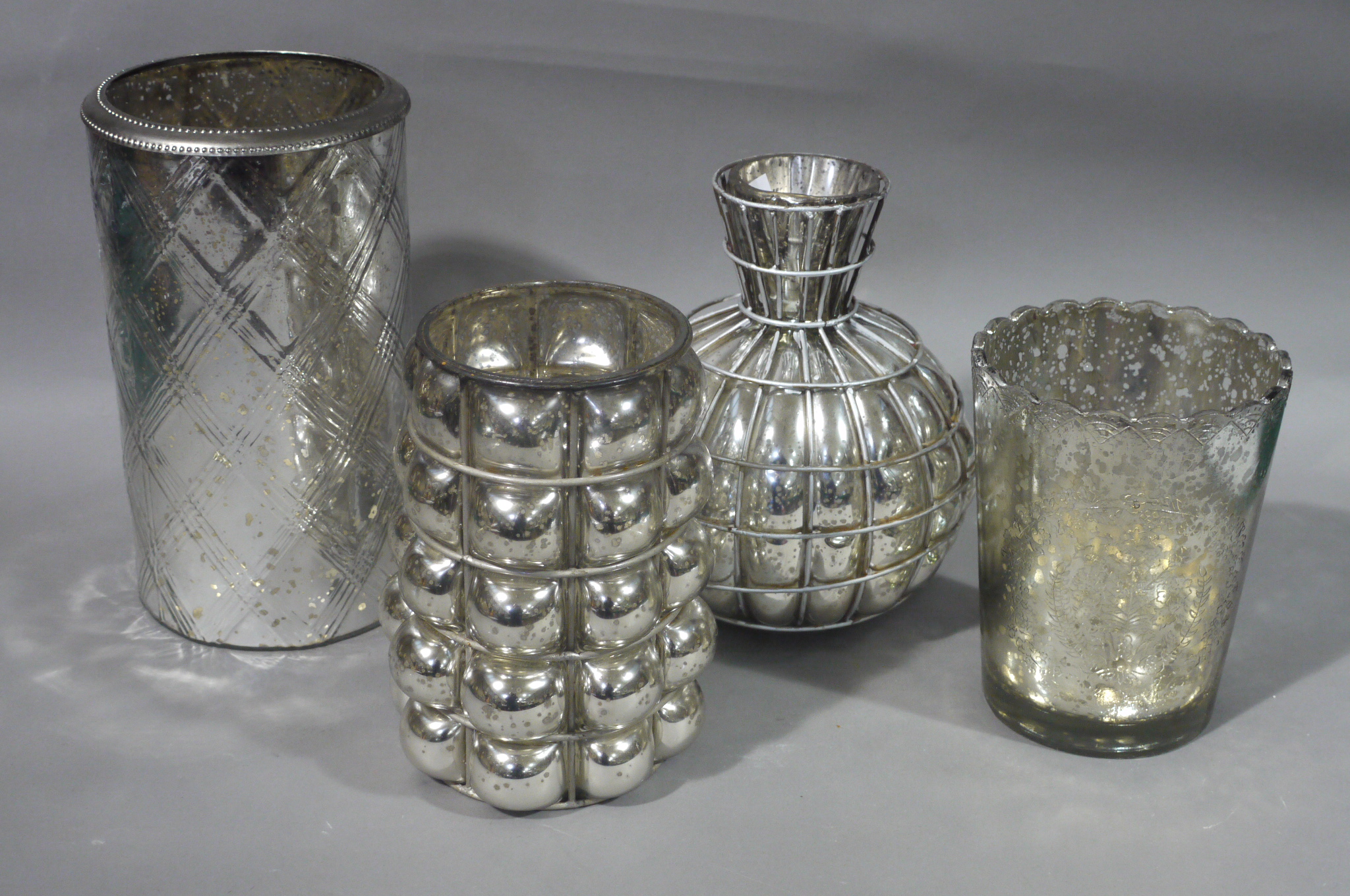 Four silvered glass vases, two wire mounted,