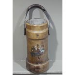 A leather shell case with transfer printed armorial crest,