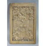 A rectangular portrait panel finely carved with stylised thistle heads and leafage on a matted