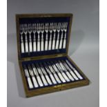 A set of twelve mother-of-pearl handled tea knives and forks with engraved silver plated blades,