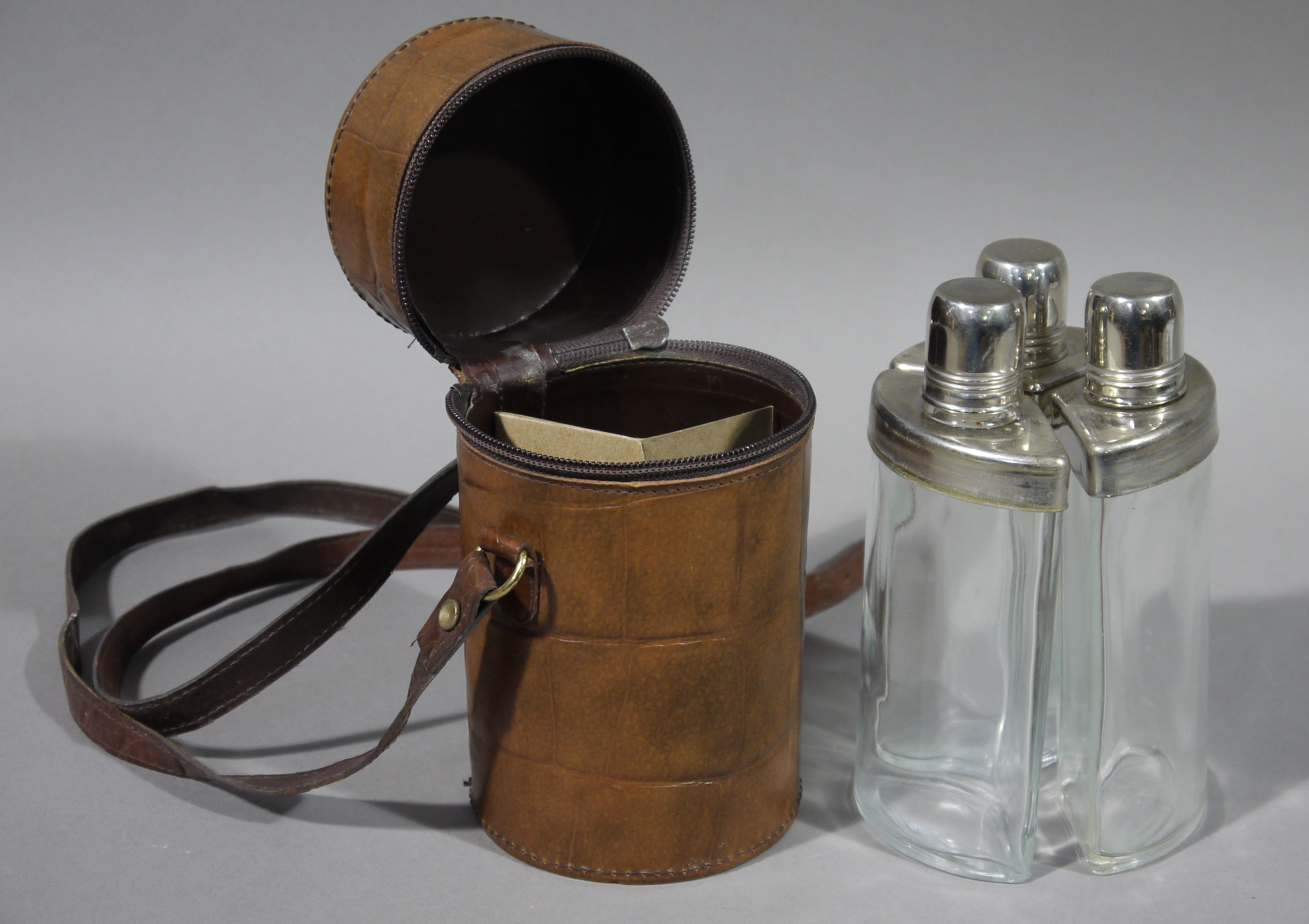 A leather cased three piece travelling/hunting flasks of triangular form with chromium plated - Image 2 of 2