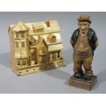 A Black Forest carved figure the caricature figure of a tramp, the square base carved trugg,