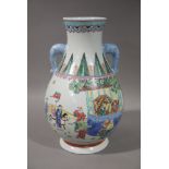 A Chinese baluster two handled vase decorated with figures on horseback and other figures in temple