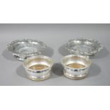 A pair of Victorian style bottle coasters with floral cast rims, 17.