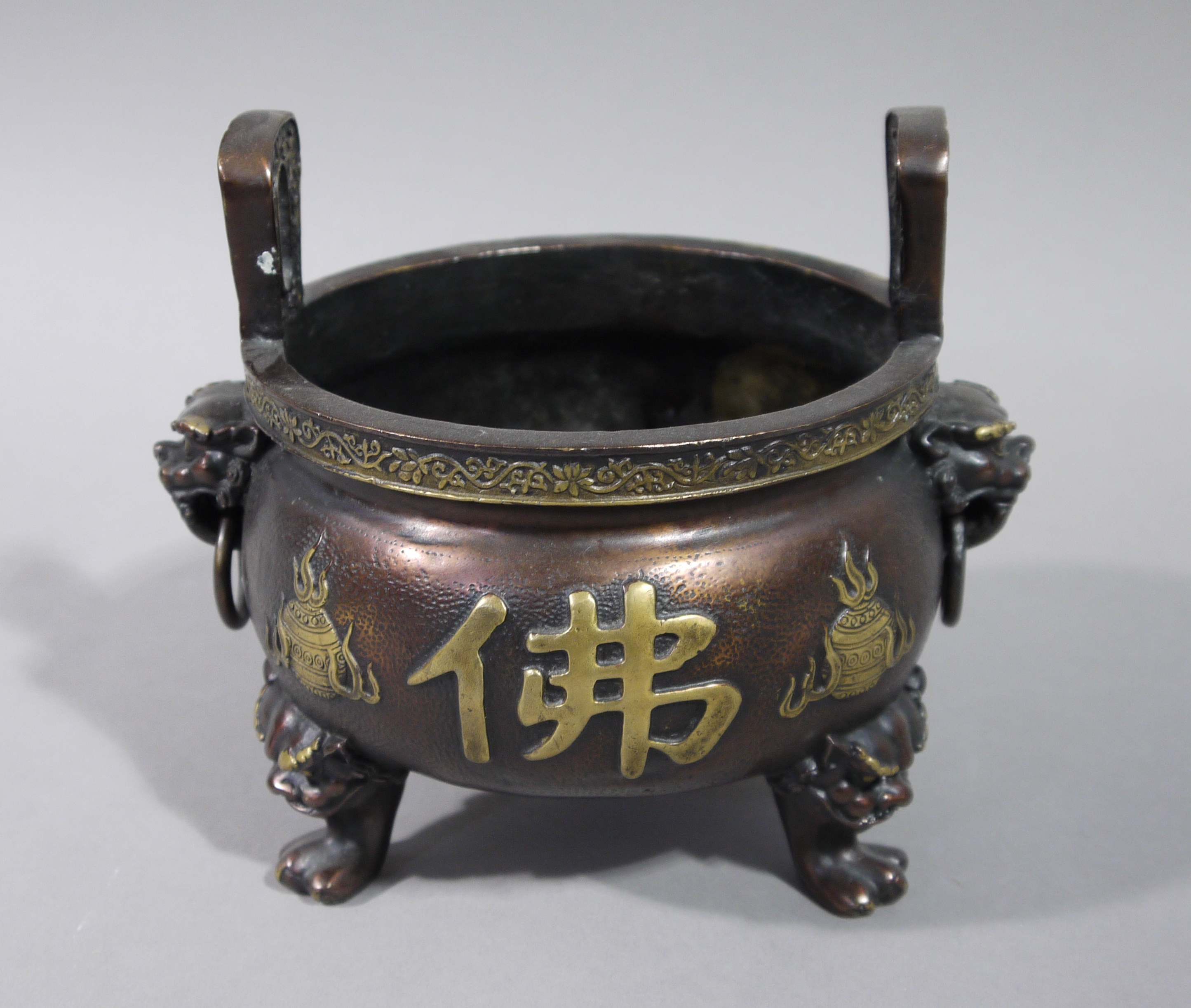 A reproduction bronze censor in Chinese style with raised pierced handles the bellied body cast