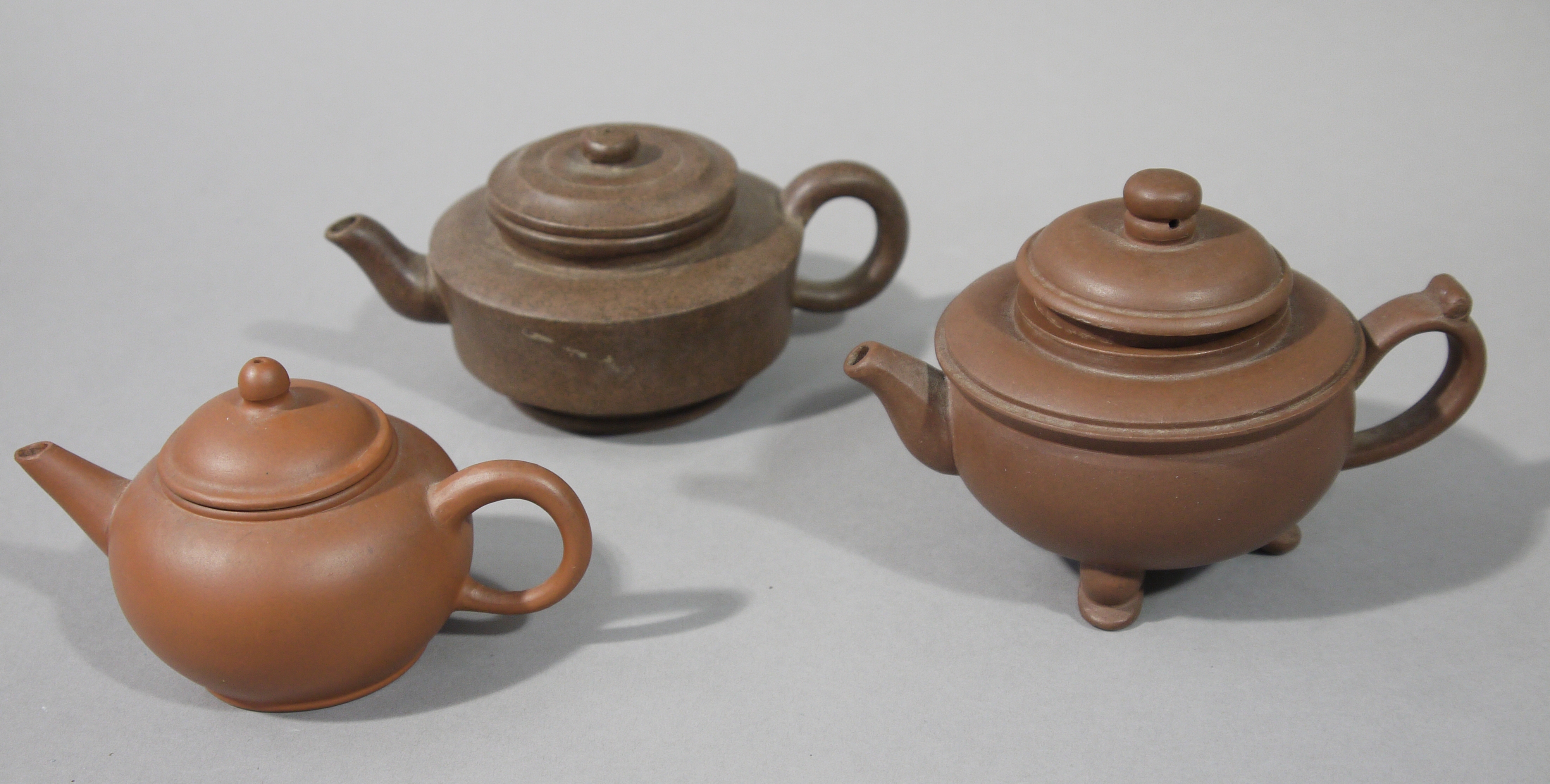 Three Yixing purple clay Chinese tea pots, various sizes,