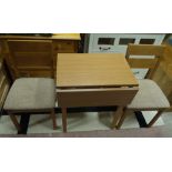 An oak effect drop leaf kitchen table with pair of kitchen chairs,