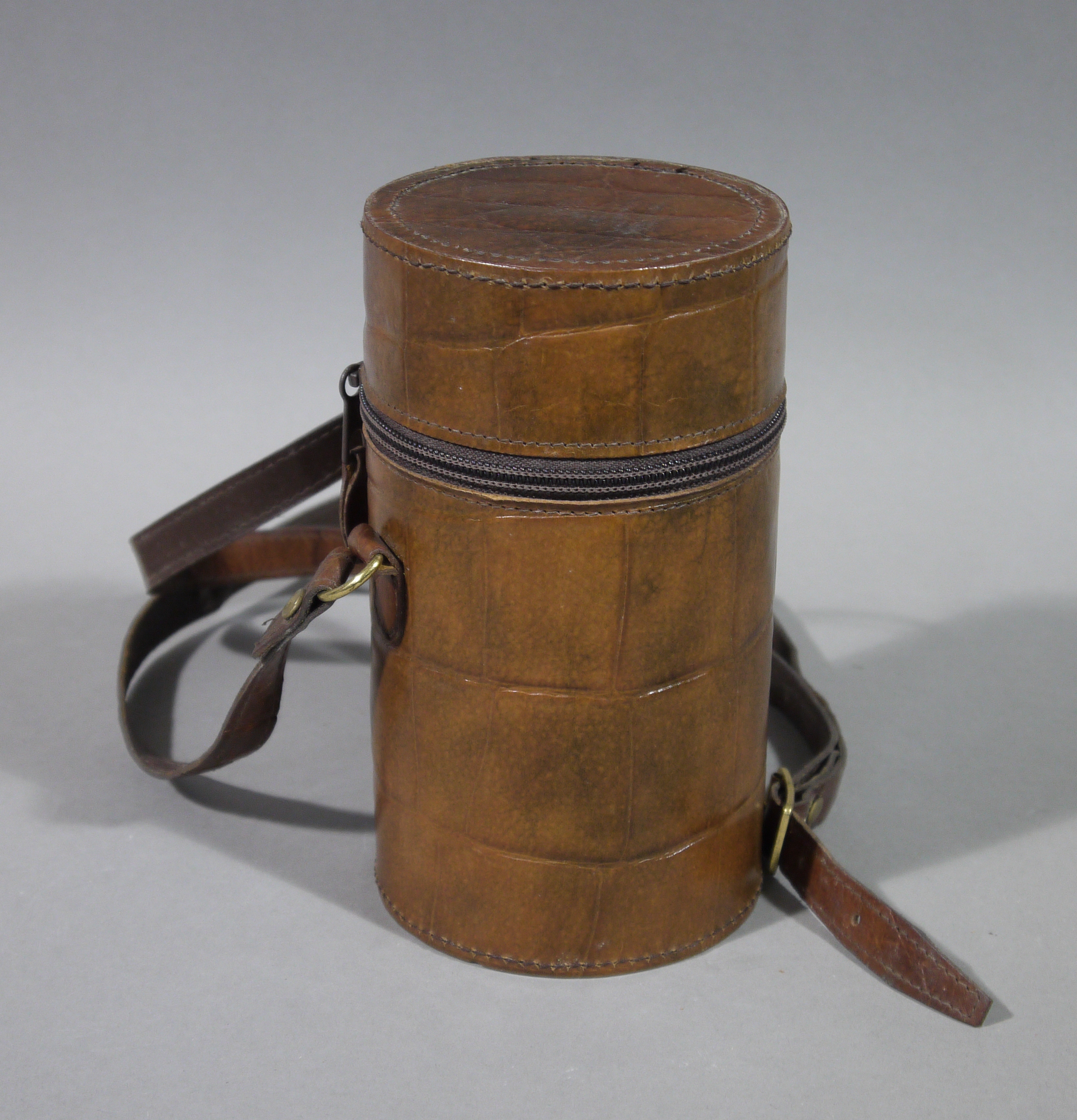 A leather cased three piece travelling/hunting flasks of triangular form with chromium plated