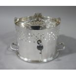 A silver plated warming stand of oval form with burner pierced upper border two handles beneath,