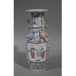 A Chinese famille rose porcelain two handled baluster vase the body painted with pair of panels of