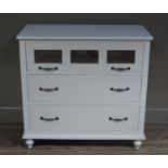 A modern cream and glazed three drawer chest on turned legs, 91cm wide,