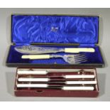 A pair of Victorian ivory handled fish servers contained in a blue silk and velvet lined fitted