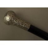 A GEORGE V GENTLEMAN'S TAPERED EBONISED HARDWOOD WALKING STICK with foliate embossed silver pommel,