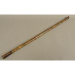 AN AUSTRALASIAN BAMBOO STAFF or baton finely engraved with stylised snakes and animals within
