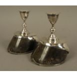A PAIR OF HORSE HOOF PRESENTATION CANDLESTICKS, each with iron shoe,