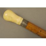 A LATE 18TH CENTURY GENTLEMAN'S WALKING STICK with marine ivory pommel and engraved silver collar,