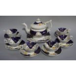 A Staffordshire tea service comprising tea pot, bread and butter plate and six cups and saucers,
