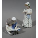 A Royal Copenhagen model of pair of infants reading a book,